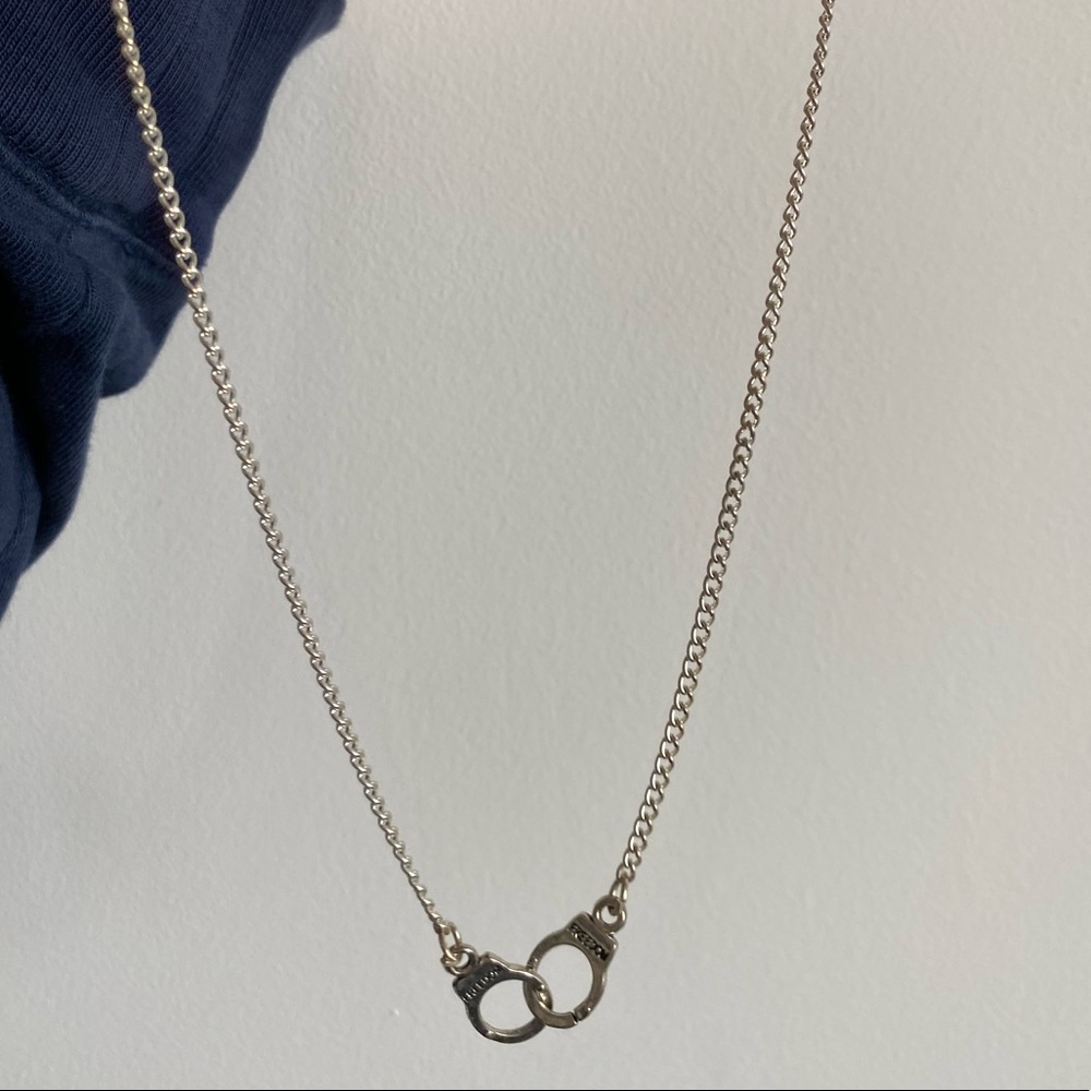 Brand new handcuff necklace with “freedom” engraving very tiny on both the cuffs